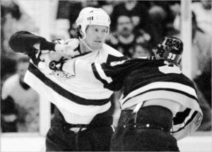 Jack McIlhargey waits to jump in on a Bob Gassoff-Paul Holmgren fight.